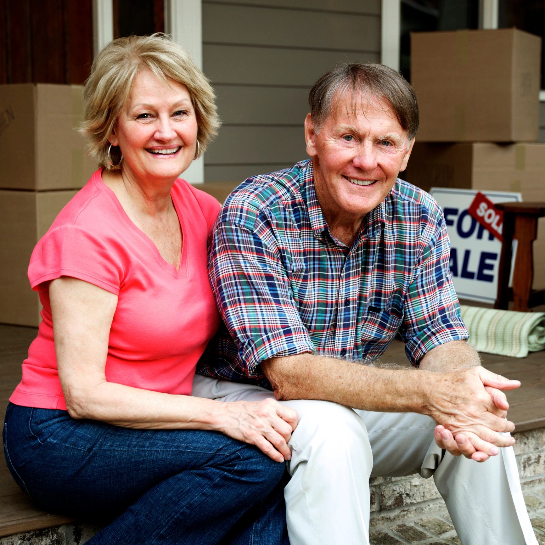 Happy senior couple outside home
