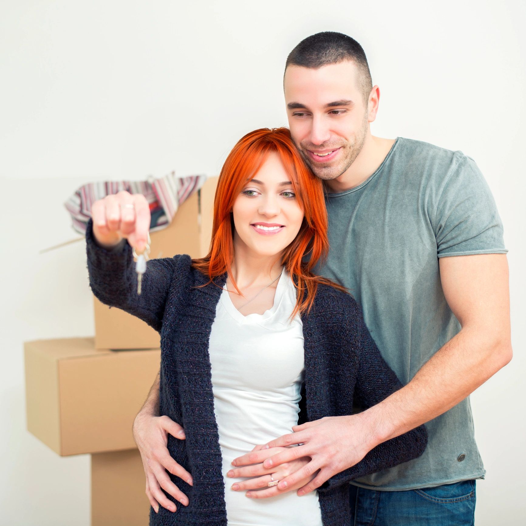 Couple holding keys in new home
